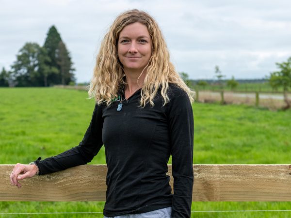 Clare Buchanan leaning on fence railing at an Align Farm